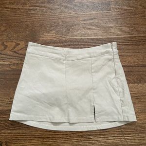 GARAGE size small mini skirt in beige with shorts underneath and side zip.